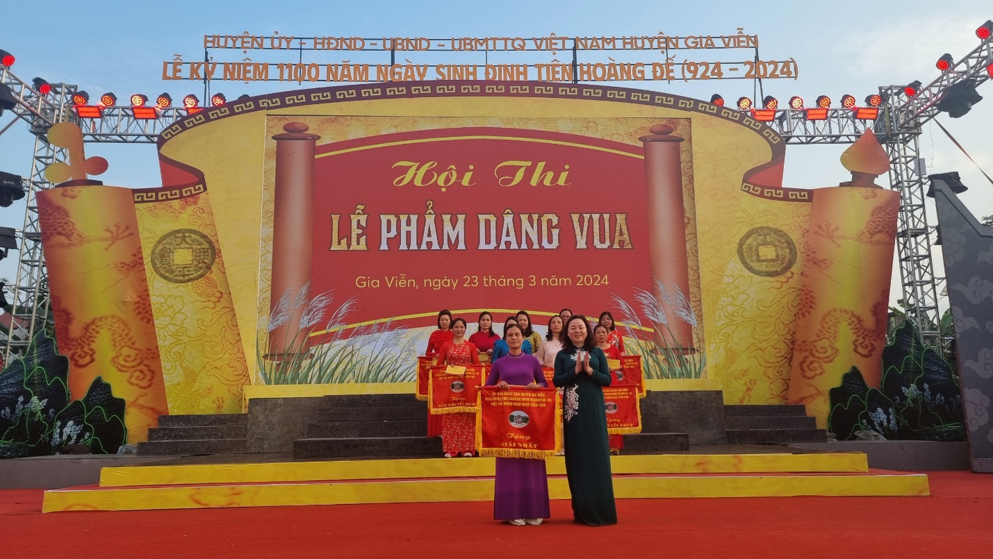 A group of people standing on a stage Description automatically generated