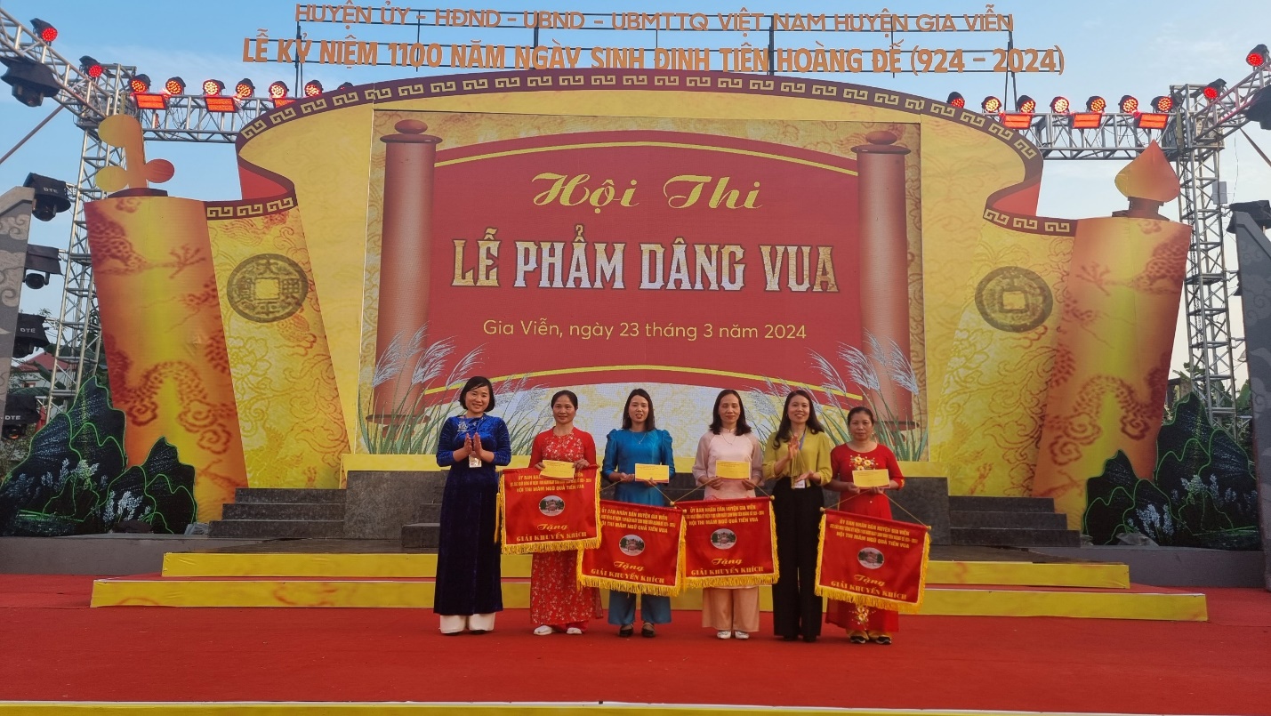 A group of women standing on a stage Description automatically generated
