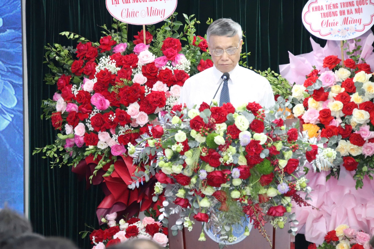 A person standing in front of a large bouquet of flowers

Description automatically generated